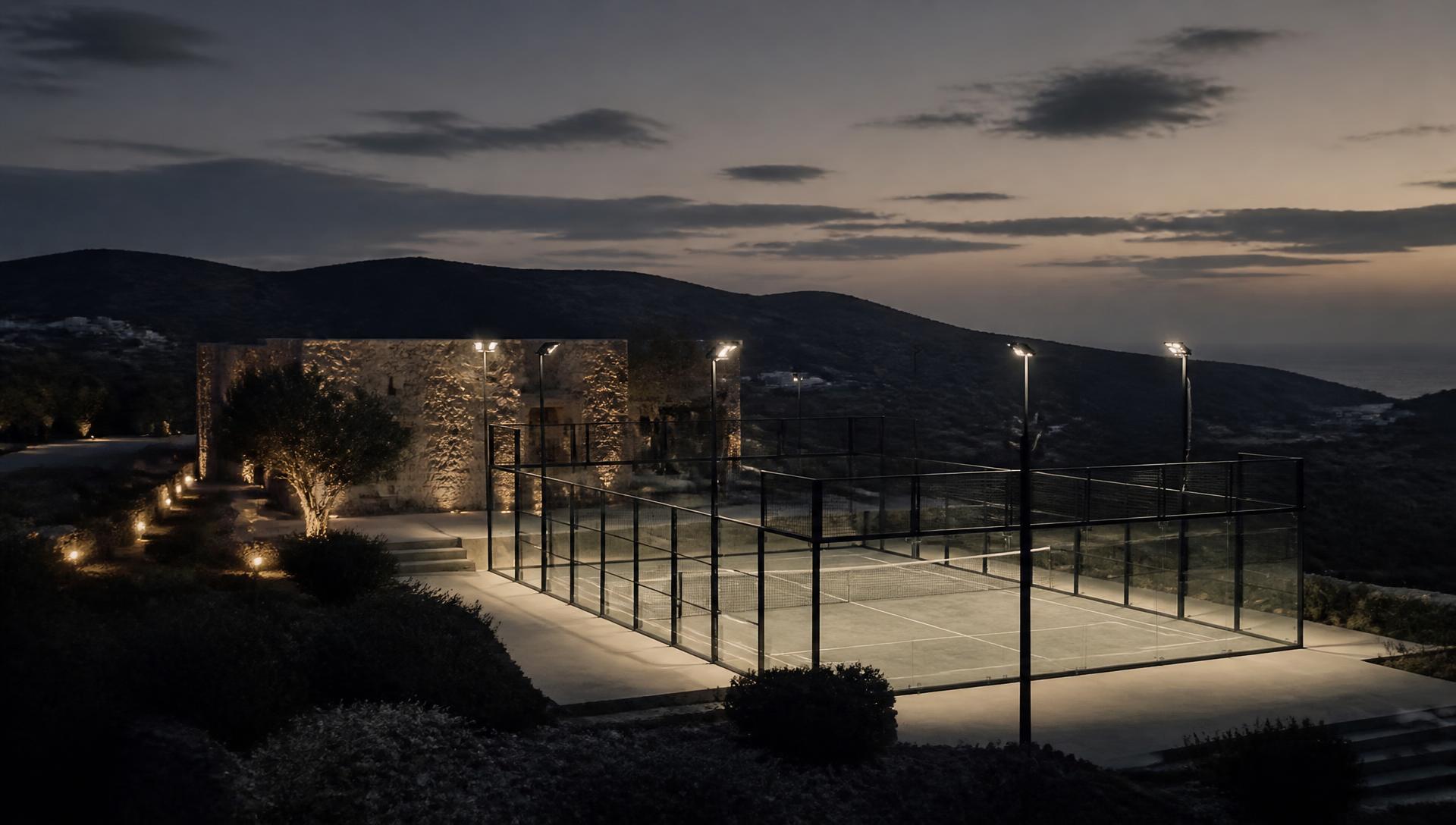 Future Verlin padel court illuminated in a mountain landscape at dusk